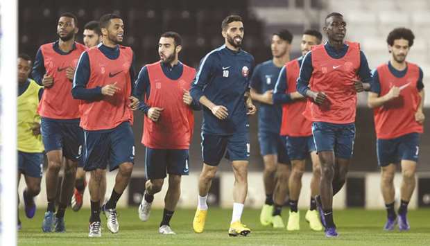 Qatar captain Hassan al-Haydos (centre) leads a training session ahead of todayu2019s friendly match against Iran.