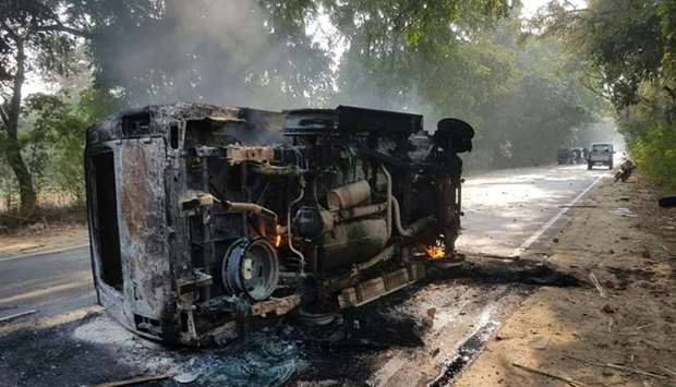 An upturned and smouldering vehicle is seen following mob violence at Chingravati village in Bulandhahr, India's northern Uttar Pradesh state yesterday.