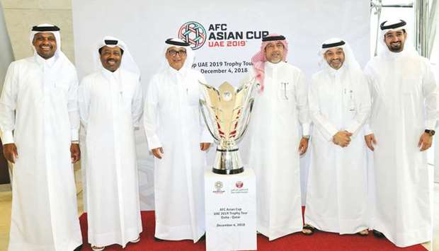 Vice-president of Qatar and Asian Football Confederation Saud al-Mohannadi, Qatar Stars League CEO Hani Ballan, Secretary General of QFA Mansour al-Ansari, Marketing Manager Khalid al-Kuwari and other officials pose with the AFC Asian Cup trophy at Al Bidda Tower yesterday.