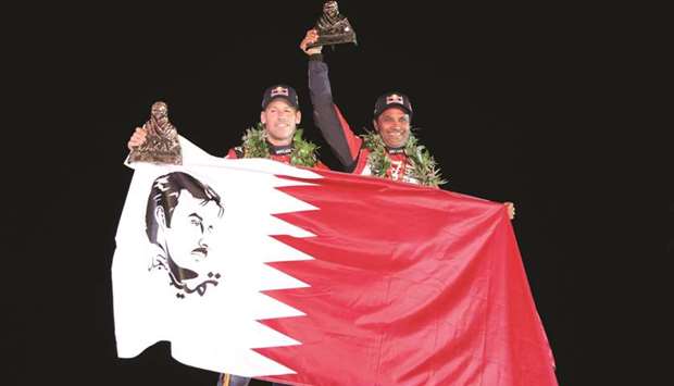 Qataru2019s Nasser al-Attiyah (R) along with his French co-driverMatthieu Baumel of Toyota Gazoo Racing team celebrate their second place finish in the Dakar Rally 2018 in Cordoba, Argentina.