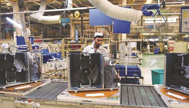 A worker seen on the production line in the Daikin air conditioning plant in Neemrana, about 120km southwest of New Delhi.