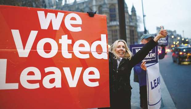 Brexit supporters hold a placard during a protest opposite the Houses of Parliament, London yesterday.