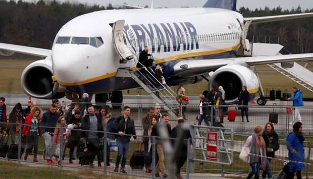 People walk on the tarmac as they leave a Ryanair aircraft at the airport in Modlin near Warsaw, Poland on November 15, 2018. Reuters