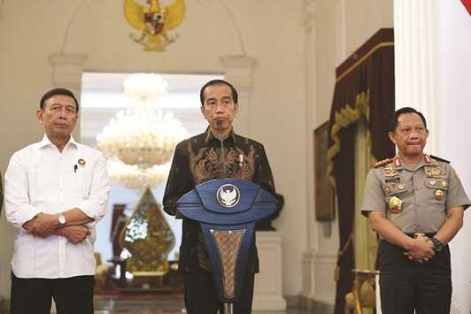 Indonesian President Joko Widodo accompanied by Coordinating Minister for Political, Legal and Security Affairs Wiranto (left) and National Police Chief Gen Tito Karnavian speaks to the media about the deaths of construction workers after a shooting in the countryu2019s easternmost province of Papua, at the palace in Jakarta, Indonesia yesterday.