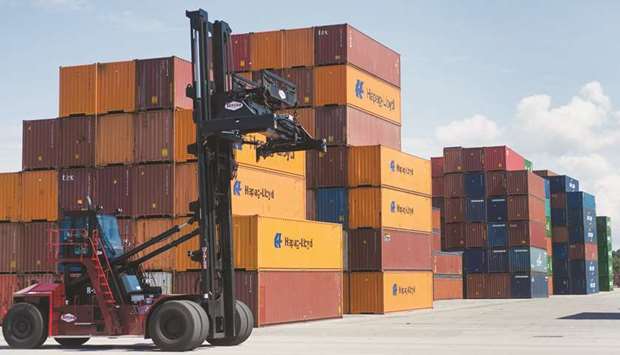 A top loader passes a row of shipping containers stacked at the Port of Savannah in Savannah, Georgia, US. The Commerce Department said the trade deficit increased 1.7% to $55.5bn, the highest level since October 2008.