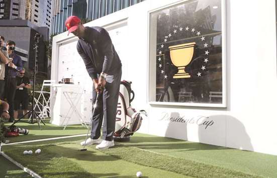 Tiger Woods putts golf balls during a media conference in Melbourne yesterday. (EPA)
