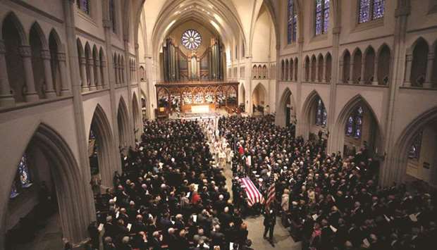 A military honour guard walks the casket out of Houstonu2019s St Martinu2019s Episcopal Church during the funeral service for former US president George HW Bush.