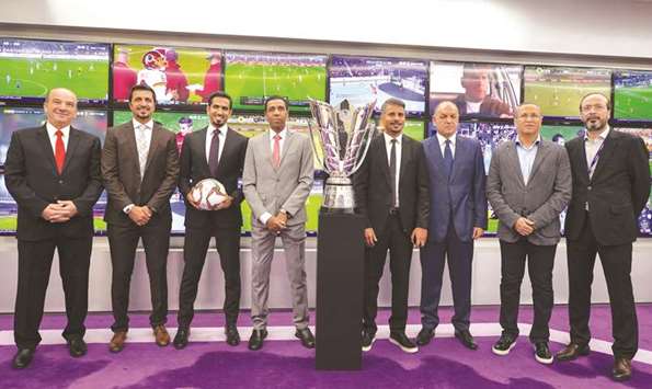 beIN presenters and football pundits pose with AFC Asian Cup trophy at beIN headquarters yesterday.