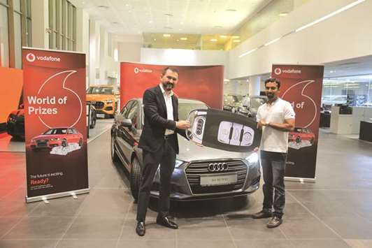 Vodafone Qataru2019s Berdiev presents the Audi car to the winner, Najeeb Varappurath.