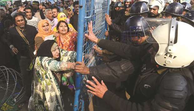 Supporters of arrested opposition leader Shehbaz Sharif scuffle with police at a corruption court in Lahore.