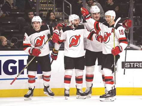 New Jersey Devils right wing Kyle Palmieri (second left) celebrates with defenseman Will Butcher (left) centre Travis Zajac (right) and defenseman Ben Lovejoy his goal scored against the Los Angeles Kings during the first period at Staples Center. PICTURE: USA TODAY Sports