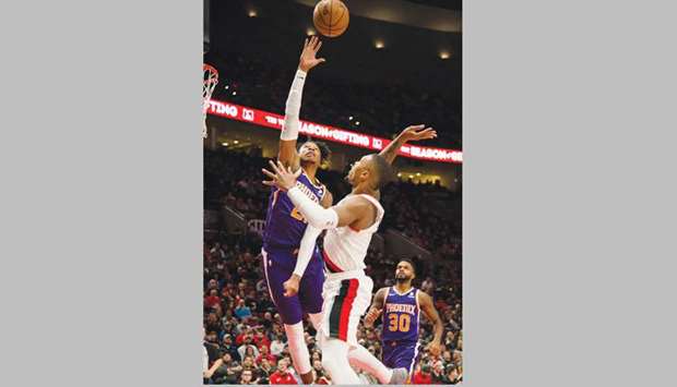 Phoenix Suns forward Richaun Holmes (left) defends the basket against Portland Trail Blazers guard Damian Lillard during the second half at Moda Center. PICTURE: USA TODAY Sports