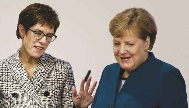 Merkel with CDU secretary general Kramp-Karrenbauer at the start of the party congress at a fair hall in Hamburg.