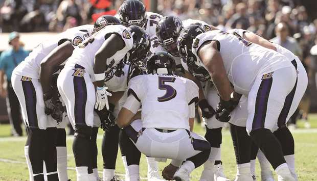 Baltimore Ravens players in the huddle during the first half of their NFL game against the Oakland Raiders at the Oakland Coliseum in Oakland, California. (EPA)