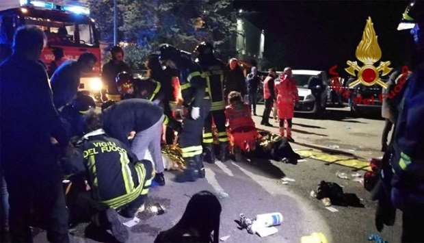 Emergency personnel attend to victims of a stampede at a nightclub in Corinaldo, near Ancona, Italy