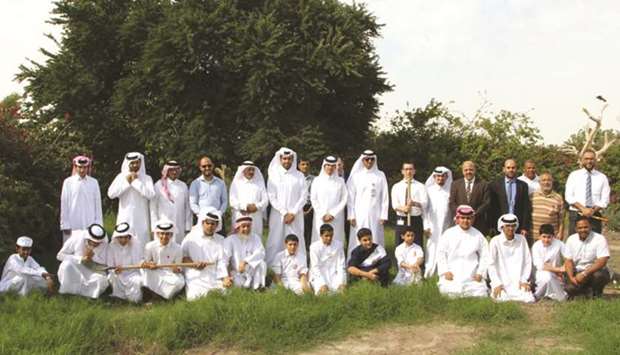 Nakilat officials and students in a group photo.