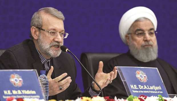 Iranu2019s Parliament Speaker Ali Larijani (left) speaks while seated next to President Hassan Rouhani, during the second Speakeru2019s Conference, which includes delegations from Afghanistan, China, Pakistan, Turkey, and Russia and focuses on terrorism and regional co-operation, in the capital Tehran, yesterday.