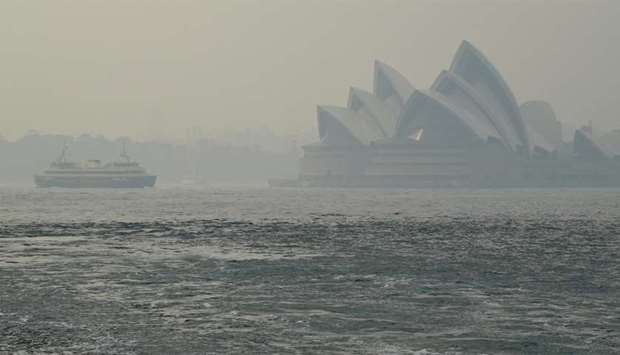 The Sydney Opera House can be seen as smoke haze from bushfires in New South Wales blankets the CBD in Sydney