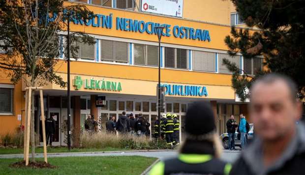 Police officers stand guard near the site of a shooting in front of a hospital in Ostrava, Czech Republic