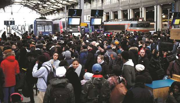 Commuters wait on a platform at Parisu2019s Gare de Lyon train station as a strike by French SNCF railway and Paris transport network (RATP) workers continues against French governmentu2019s pensions reform plans.