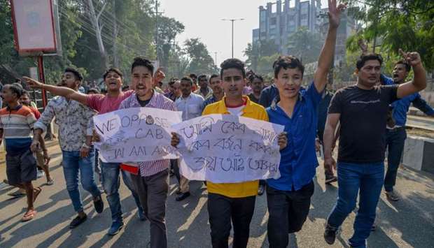 Citizens shout slogans as they take part in a protest procession during the strike called by North East Students' Organization (NESO) against the government's Citizenship Amendment Bill (CAB), in Guwahati