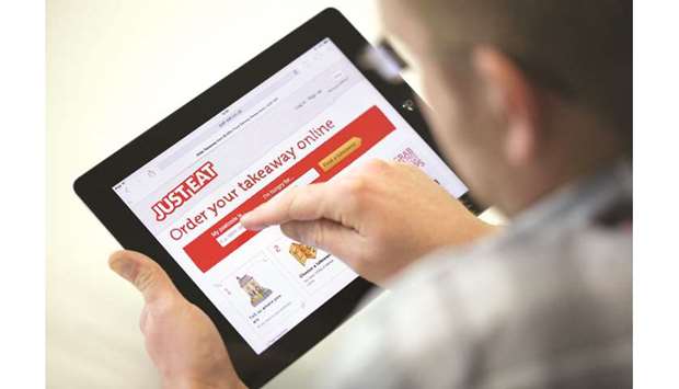 A customer checks the website of Just Eat in London. While the Takeaway.com deal values Just Eat shares at about 694 pence, the merger would create a sizeable European food-delivery company to compete with the likes of Uber Eats.