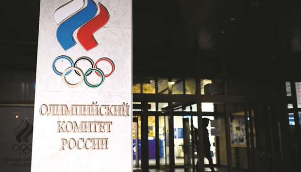 A person walks out of the Russian Olympic Committee (ROC) headquarters in Moscow on Monday. Russia will miss next yearu2019s Tokyo Olympics and the 2022 Beijing Winter Games after the World Anti-Doping Agency on Monday banned the powerhouse from global sporting events for four years over manipulated doping data. (AFP)