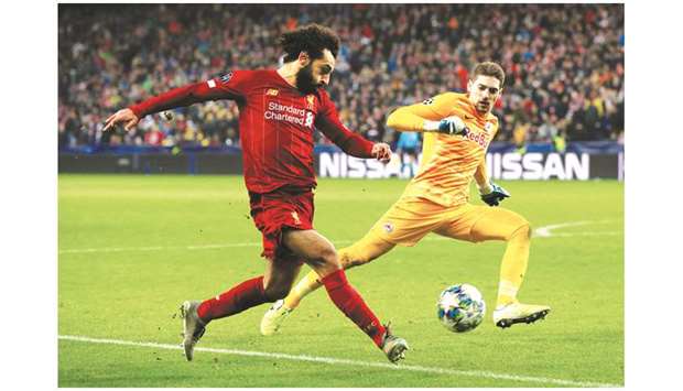 Liverpoolu2019s Mohamed Salah (left) scores against Salzburg in the  Champions League Group E match yesterday.  b(Reuters)
