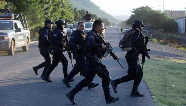Police officers patrol at a road after fellow police officers were killed during an ambush by suspected cartel hitmen in El Aguaje, in Michoacan state, Mexico. File picture October 14, 2019.