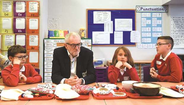 Opposition Labour party leader Jeremy Corbyn sits with school children during a campaign event at Sandylands Community Primary School in Morecambe yesterday.
