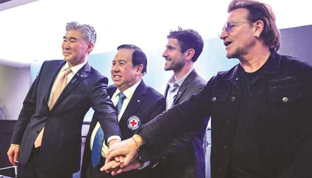 (From left) US ambassador to the Philippines Sung Kim, Philippine Red Cross chairman Richard Gordon, Zipline CEO Keller Rinaudo and U2 frontman Bono pose for a photo during a signing ceremony in Manila, yesterday.