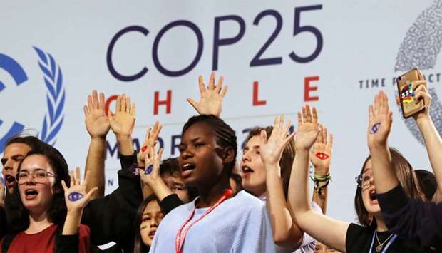 Climate change activist Greta Thunberg is seen behind young climate activists on stage at the High-Level event on Climate Emergency during the UN Climate Change Conference (COP25) in Madrid