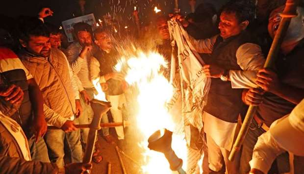 Members of the youth wing of India's main opposition Congress party burn a copy of Citizenship Amendment Bill, a bill that seeks to give citizenship to religious minorities persecuted in neighbouring Muslim countries, during a protest in New Delhi