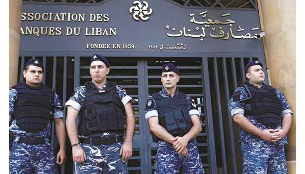 Lebanese police stand outside the entrance to the Association of Banks in downtown Beirut (file). After repaying $1.5bn Eurobonds that matured last month, the focus is turning to whether authorities will honour a $1.2bn commitment on March 9. Several influential local economists and even some officials say the country should use its dwindling reserves to pay for imports instead of creditors.
