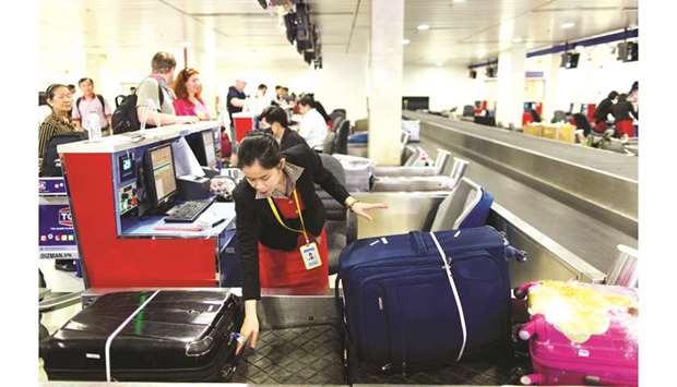 An employee handles baggage at a check-in counter at the Tan Son Nhat International Airport in Ho Chi Minh City, Vietnam. The International Air Transport Association, in partnership with the Global Shippers Forum (GSF), the International Federation of Freight Forwarders Associations (FIATA) and the International Air Cargo Association (TIACA), are amplifying their efforts to ensure the safe air transport of lithium batteries.