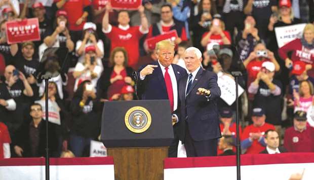 President Donald Trump gestures with Vice President Mike Pence during a campaign rally in Hershey, Pennsylvania. The rally marks the third time President Trump has held a campaign rally at Giant Centre.