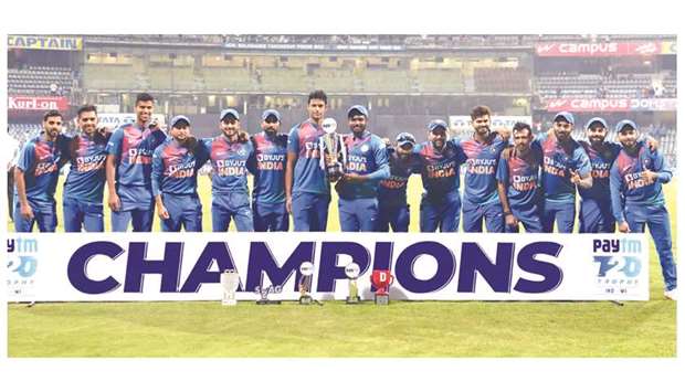 Team India pose with trophy after winning the three-match series against West Indies at the Wankhede Stadium in Mumbai yesterday. (AFP)