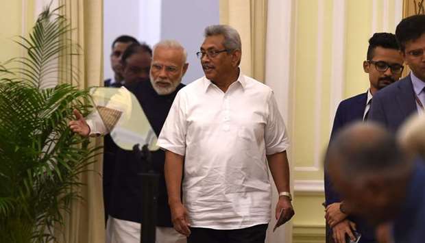 Sri Lanka's President Gotabaya Rajapaksa (C) and India's Prime Minister Narendra Modi (C-L) arrive for a joint media briefing at the Hyderadad House in New Delhi
