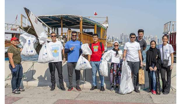 GROUP: Carlos Hernandez, Ambassador of Argentina to Qatar, second from left, with Global Shapers with the plastic and other rubbish they collected in Doha Corniche.