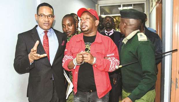 Governor Mike Sonko (centre) is escorted after the High Court granted him bail at the Milimani law court in Nairobi, yesterday.