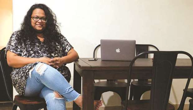 In this photograph taken on October 26, 2019 Vandita Morarka, 25, poses for a picture as she sits around rented furnitures during an interview with AFP in Mumbai.