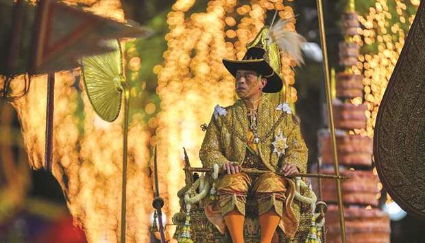Thailandu2019s King Maha Vajiralongkorn is carried on a sedan-chair after taking part in the Royal Barge procession near the Grand Palace in Bangkok, Thailand.