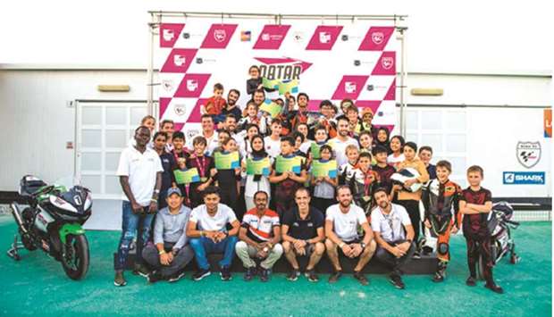 Young riders pose after the first round of the QMA Challenge at the Losail Circuit Sports Club.