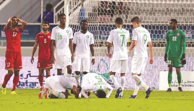 Saudi Arabiau2019s players (in white) react to scoring a goal during the 24th Arabian Gulf Cup Group B match against Bahrain on Saturday. (AFP)