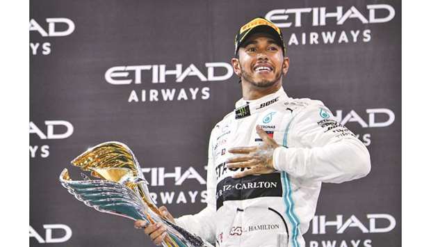 Mercedesu2019 British driver Lewis Hamilton celebrates his win at the Yas Marina Circuit in Abu Dhabi, after the final race of the Formula One Grand Prix season, yesterday. (AFP)