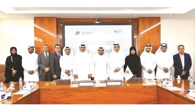 QU, Qafco officials at the signing ceremony.