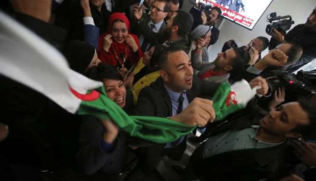 Supporters react at the campaign headquarters of Abdelmadjid Tebboune after he was announced as the new president, in Algiers