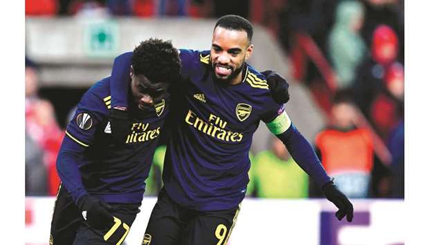 Arsenalu2019s Bukayo Saka (left) celebrates with Alexandre Lacazette after scoring during the UEFA Europa League Group F football match against Standard de Liege in Sclessin, Belgium. (AFP)