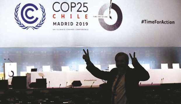 A man gestures in front of empty chairs, on the last day of the UN climate Change Conference COP25 at the u2018IFEMA - Feria de Madridu2019 exhibition centre, in Madrid.