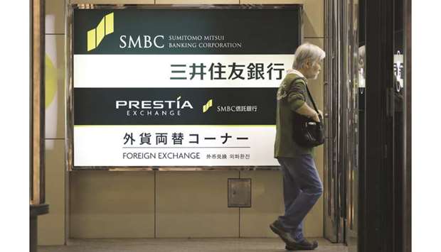 Signage for Sumitomo Mitsui Banking Corp is displayed outside its branch in Tokyo. The Japanese lender plans to ring-fence such growth spending from its targeted expense ratio in the three-year business plan starting next April, chief executive officer Jun Ohta said.